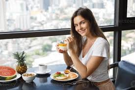 Mulher feliz tomando café da manhã