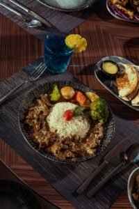 Delicious Middle Eastern dish featuring rice, vegetables, and meat served on a dining table in Baghdad.